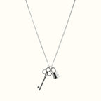 DUGO silver-tone key and lock pendant necklace on a delicate chain, minimalist waterproof jewelry for everyday wear.