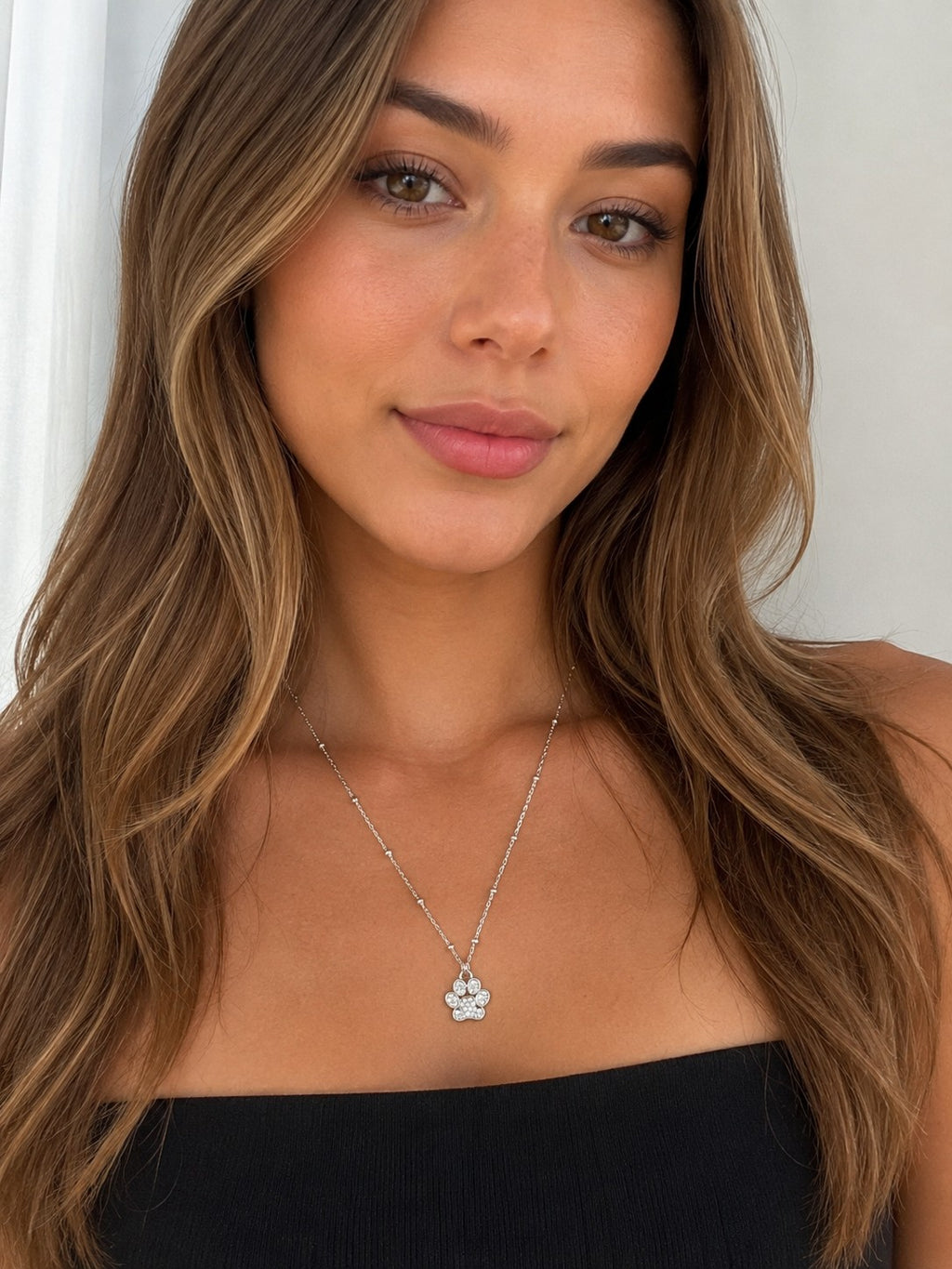 Close-up of the DUGO silver Paw Pendant Necklace worn on the neck