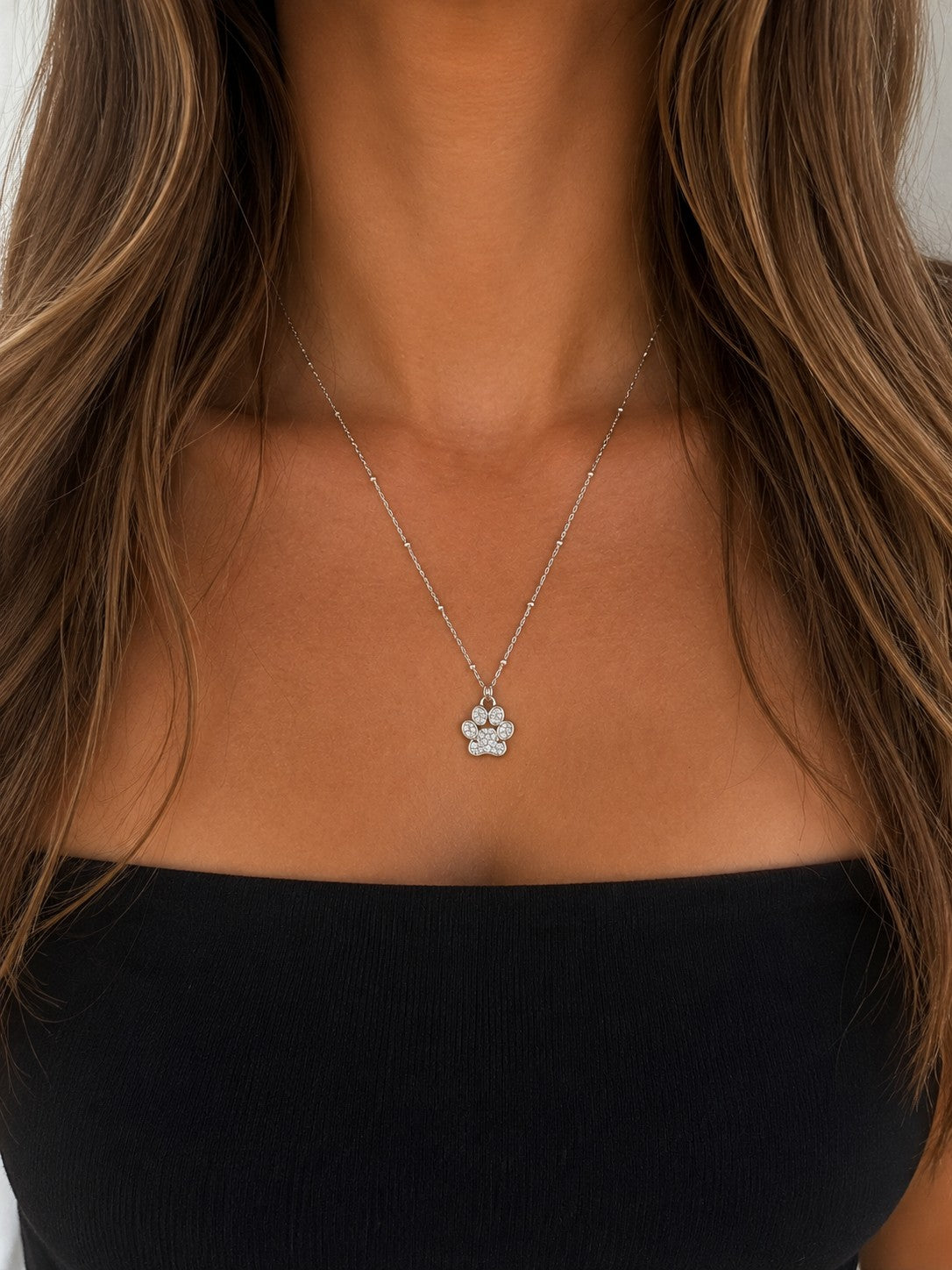 Woman wearing the DUGO silver Paw Pendant Necklace