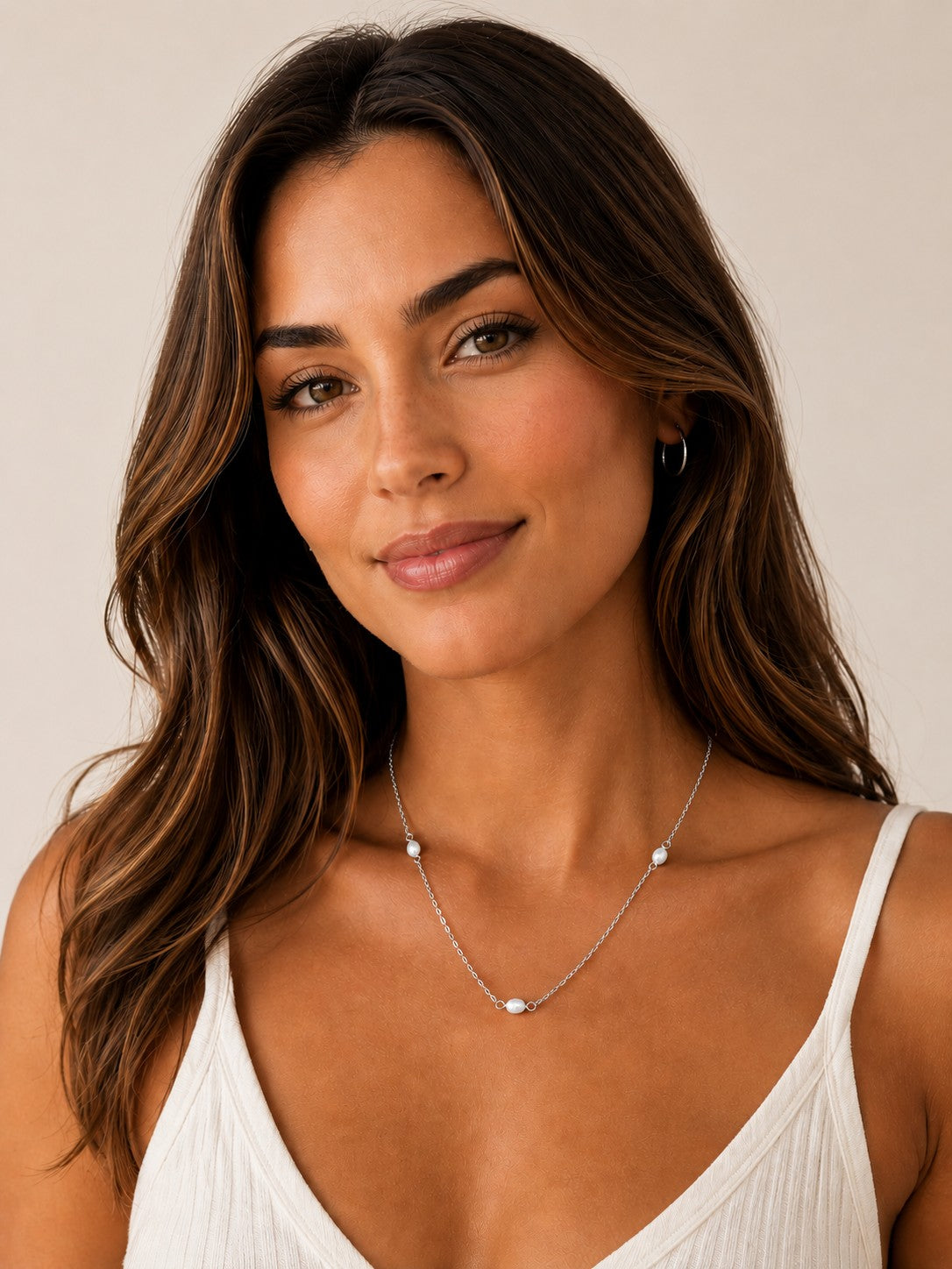 Close-up of the DUGO silver Pearl Station Necklace worn on the neck