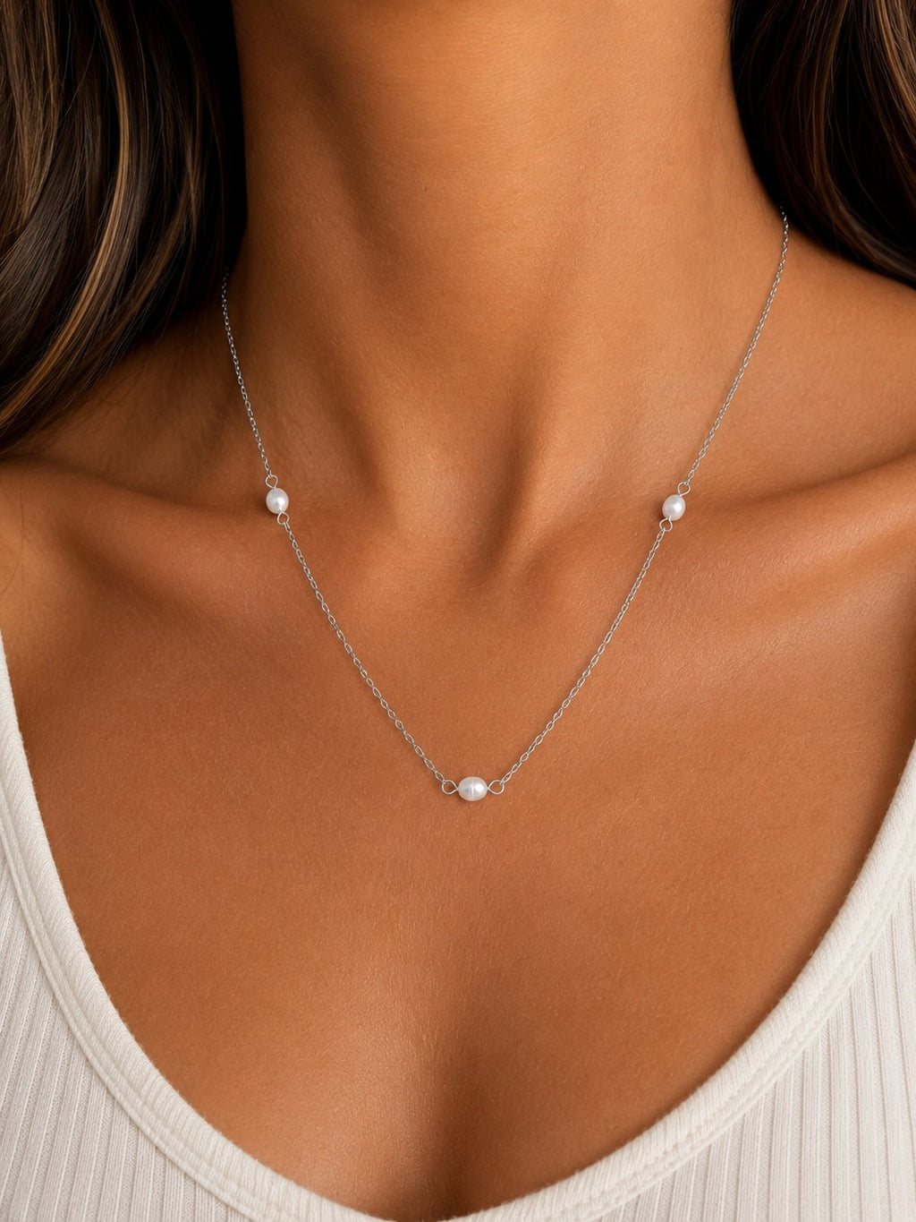 Woman wearing the DUGO silver Pearl Station Necklace