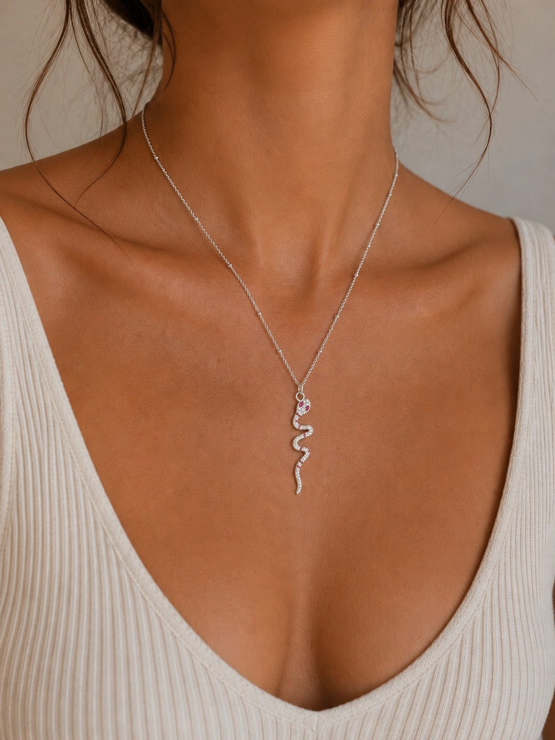Woman wearing the DUGO silver Snake Ruby Eye Necklace