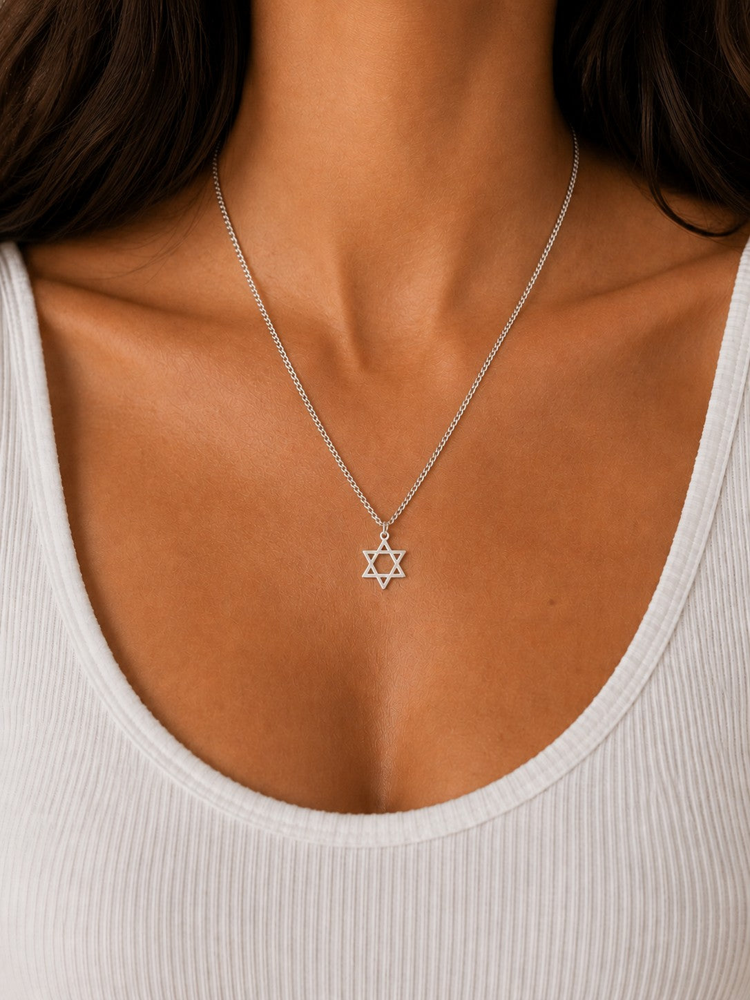 Close-up of the DUGO silver Star David Classic Necklace worn on the neck