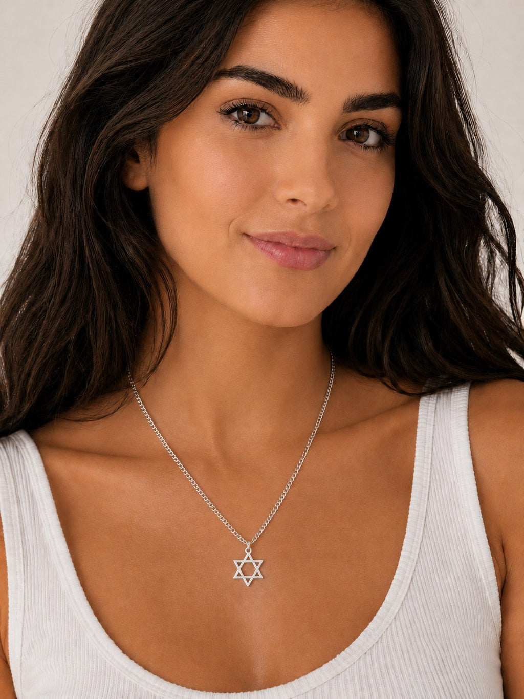 Close-up of the DUGO silver Star David Classic Necklace worn on the neck