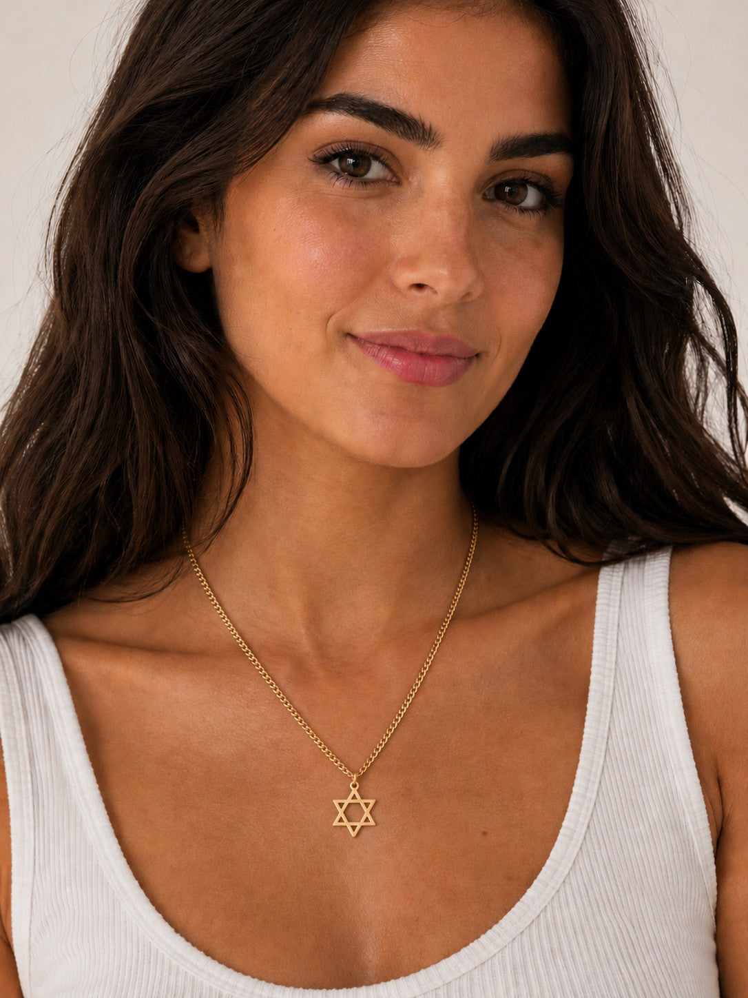 Woman wearing the DUGO silver Star David Classic Necklace