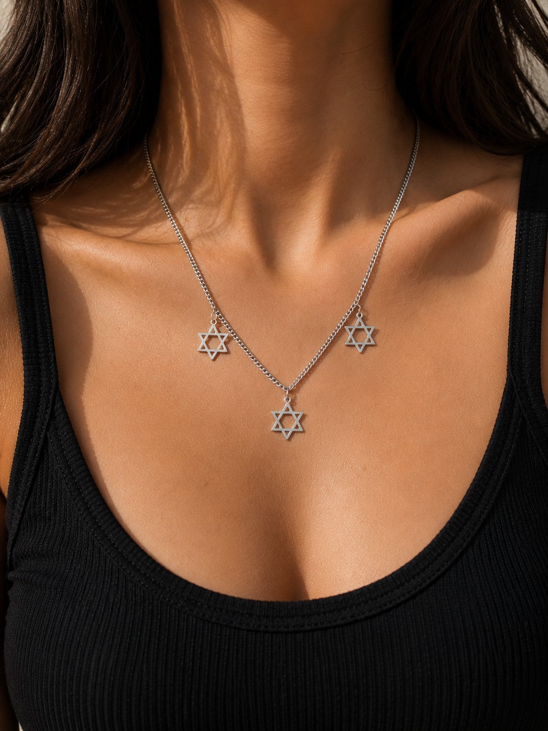 Woman wearing the DUGO silver Star David Classic Trio Necklace