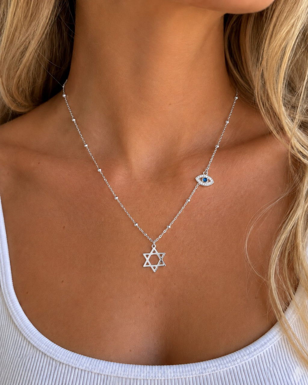 Woman wearing the DUGO silver Star David Classic with Evil Eye Charm Necklace