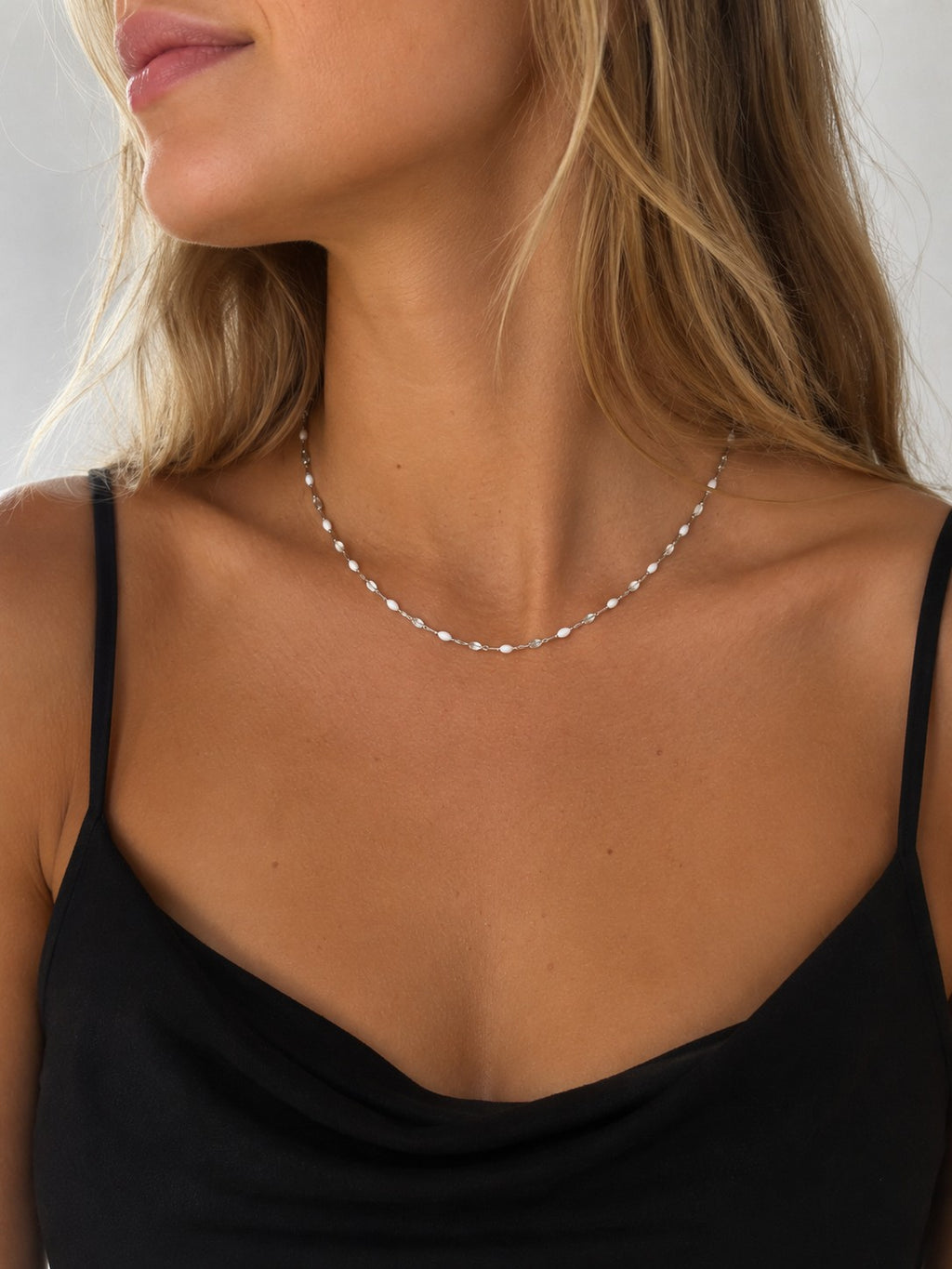 Close-up of the DUGO silver white Enamel Lip Chain Necklace worn on the neck