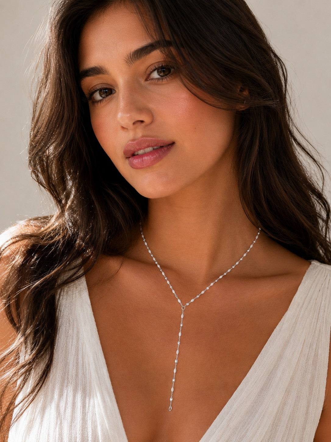 Close-up of the DUGO silver white Enamel Y Lariat Necklace worn on the neck