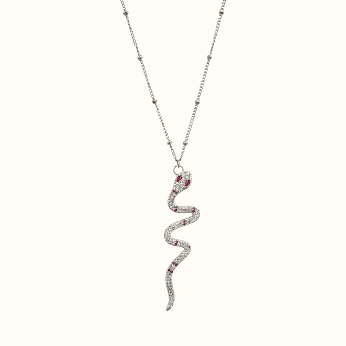DUGO snake pendant necklace in silver tone with ruby red cubic zirconia accents on a delicate beaded chain