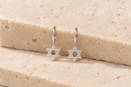 DUGO pavé Star of David Hoop Earrings on travertine stone
