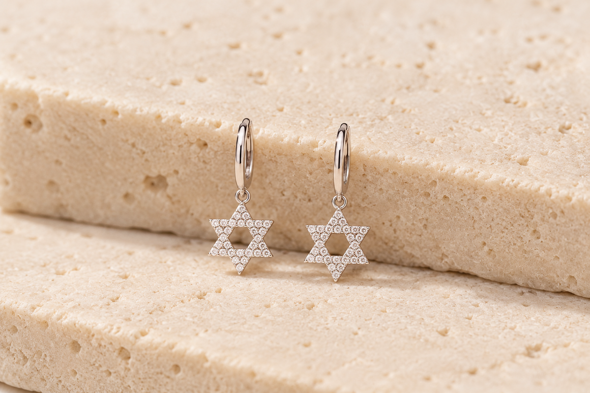 DUGO pavé Star of David Hoop Earrings on travertine stone