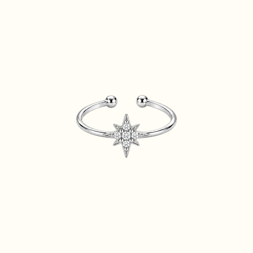 DUGO silver starburst ring with crystal accents and an adjustable open band design on a white background.