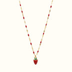 DUGO strawberry charm necklace with a red pendant on a gold-tone chain featuring small red bead accents