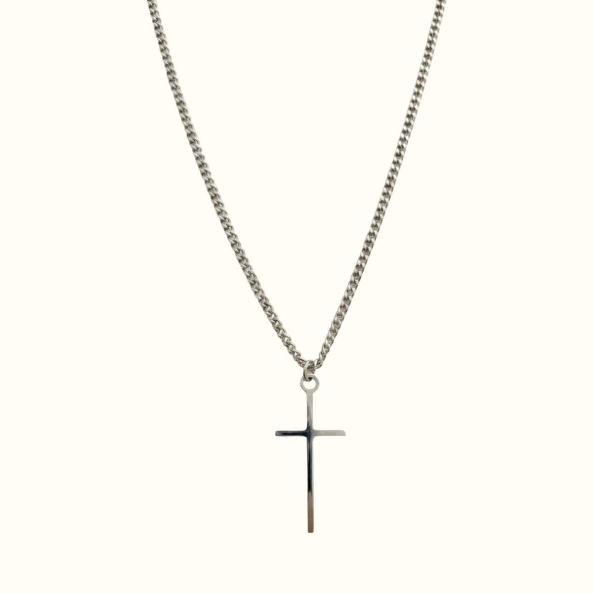 DUGO Cross Tiny necklace featuring a minimalist silver-tone cross pendant on a delicate curb chain